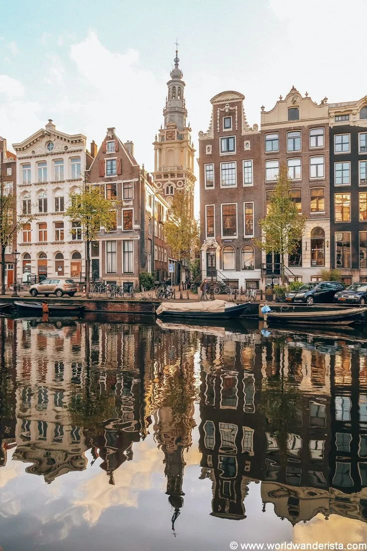 Canal houses reflected in the water in Amsterdam