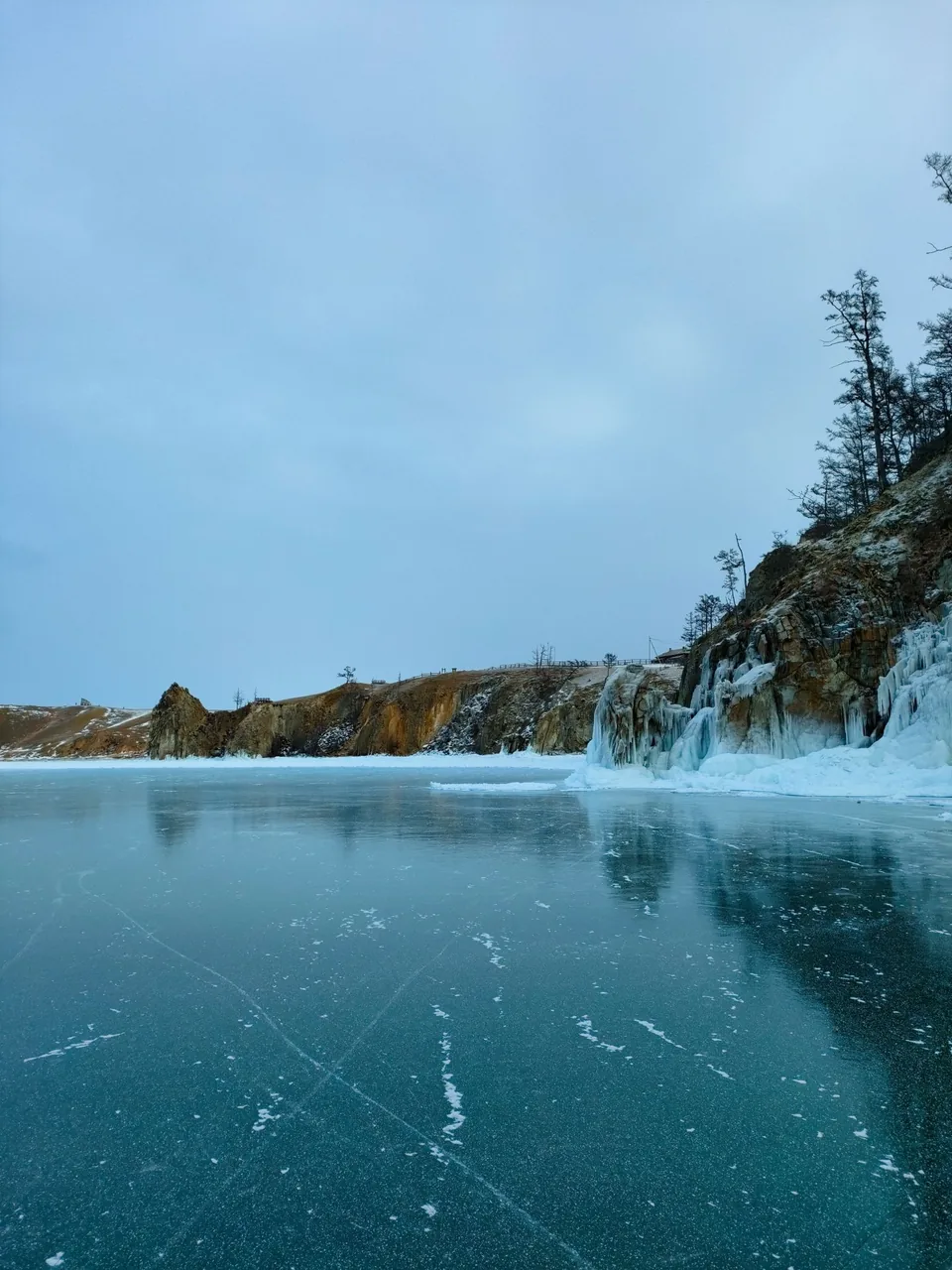 Frozen Lake Baikal beneath icy cliffs