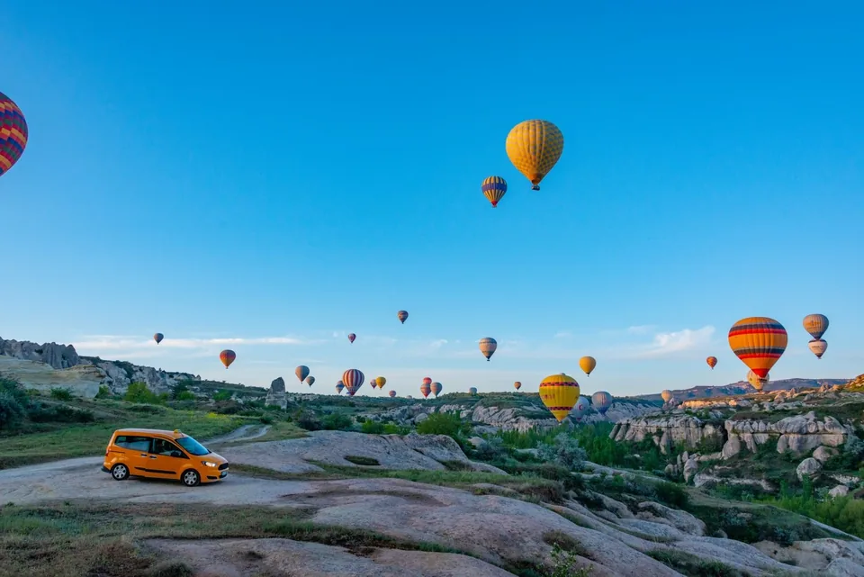 Hot-air balloons above Cappadocia rock formations